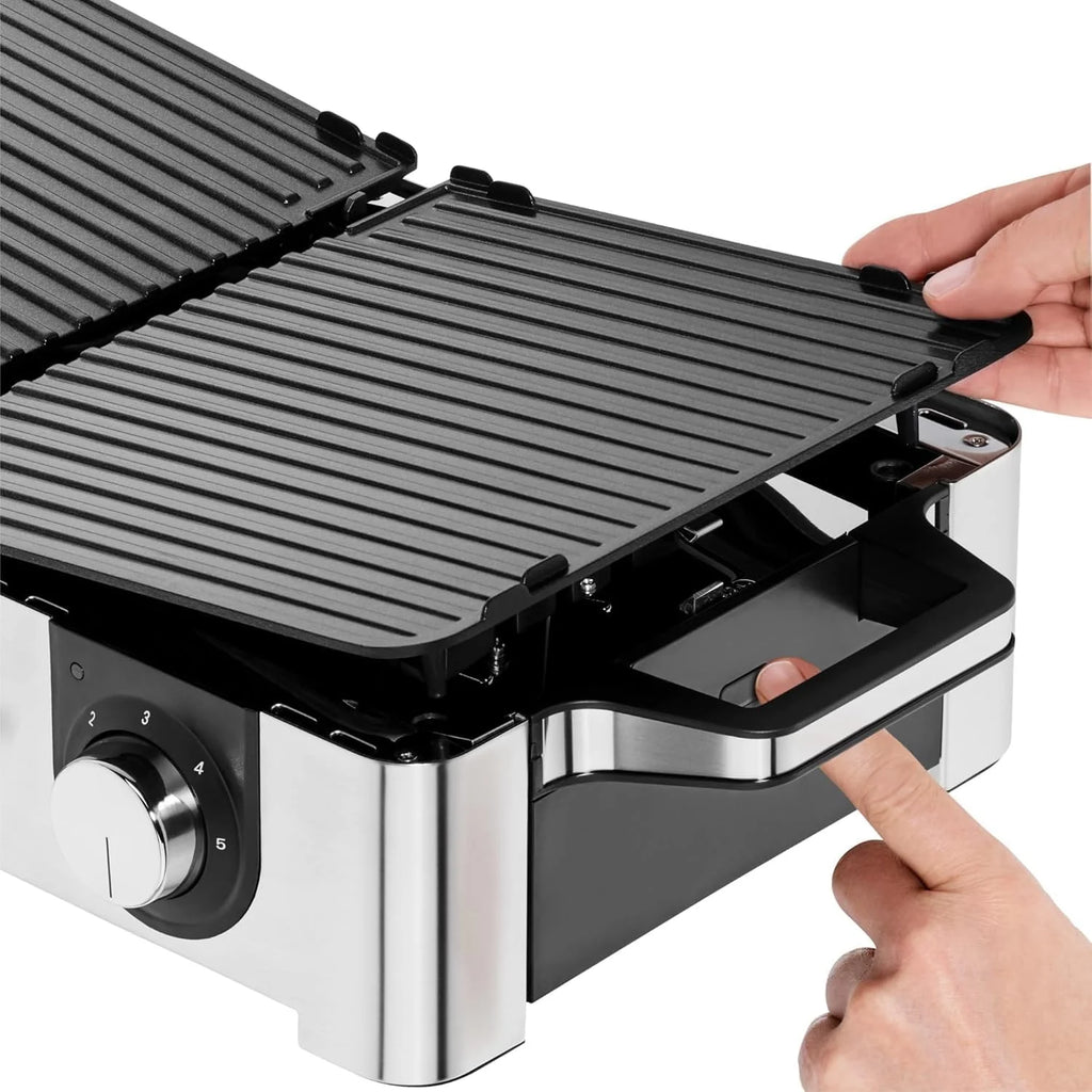 Parrilla eléctrica WMF Lono Master Grill 2026, 50x28 cm, parrilla de mesa eléctrica con paravientos y bandeja recogegrasa, certificada para uso exterior, 2 superficies de cocción ajustables independientemente, 2400 W, acero inoxidable mate.